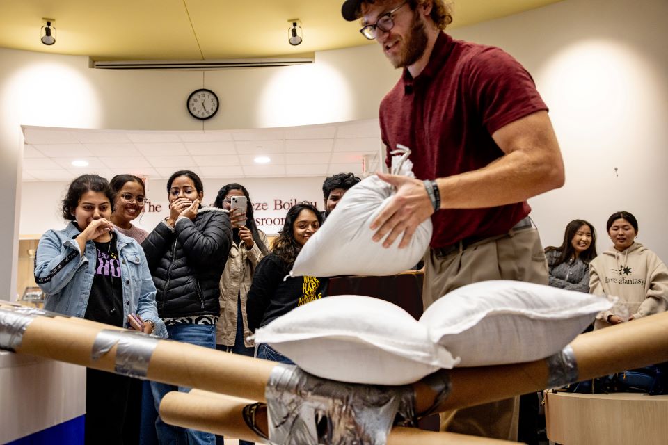 School of Science and Engineering students construct a bridge out of cardboard and duct tape during the SSE Innovation Challenge with industry partner TWM on Wednesday, Nov. 13, 2024. Photo by Sarah Conroy. 