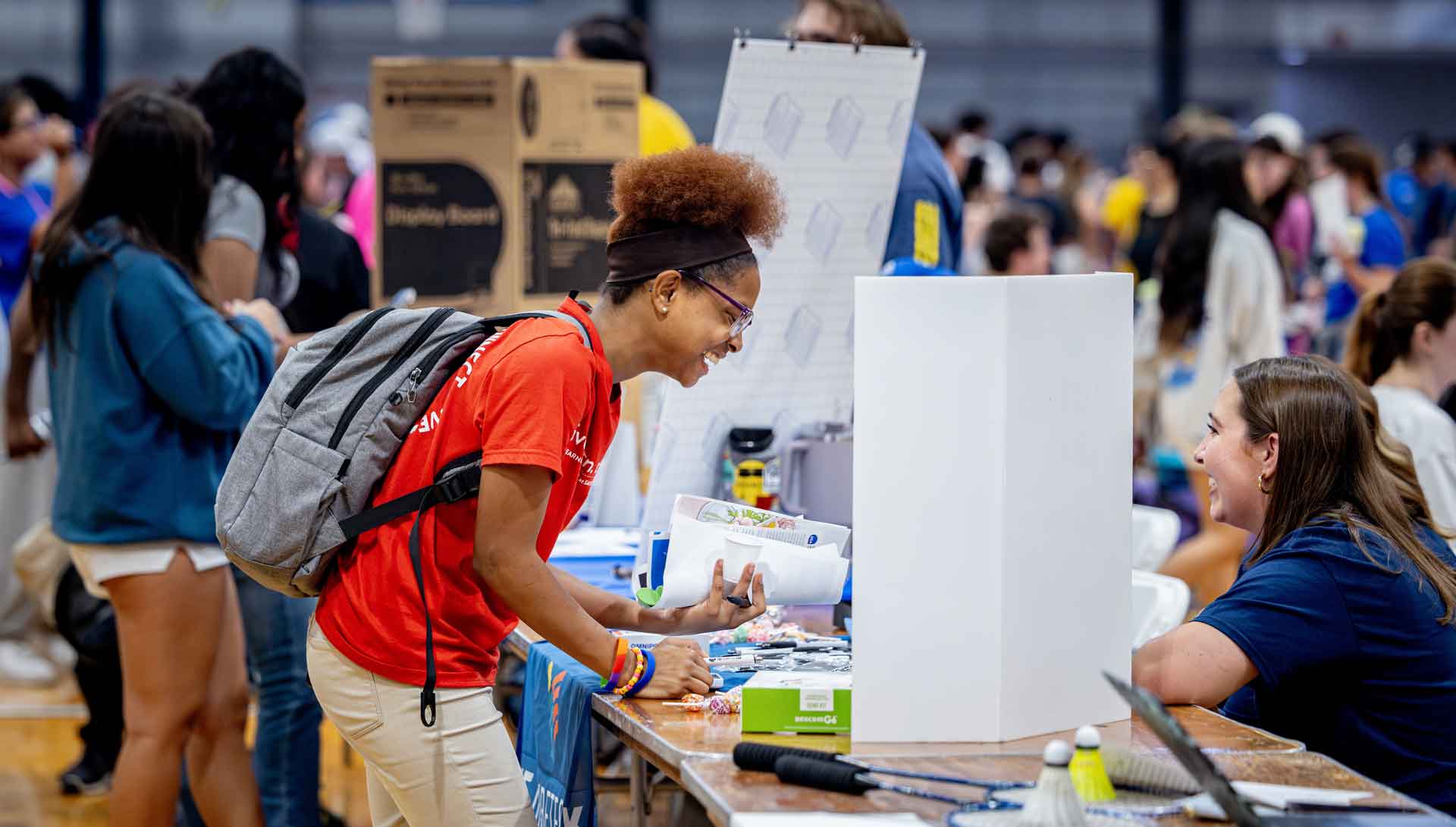 At a campus involvement fair, students talk at an information table