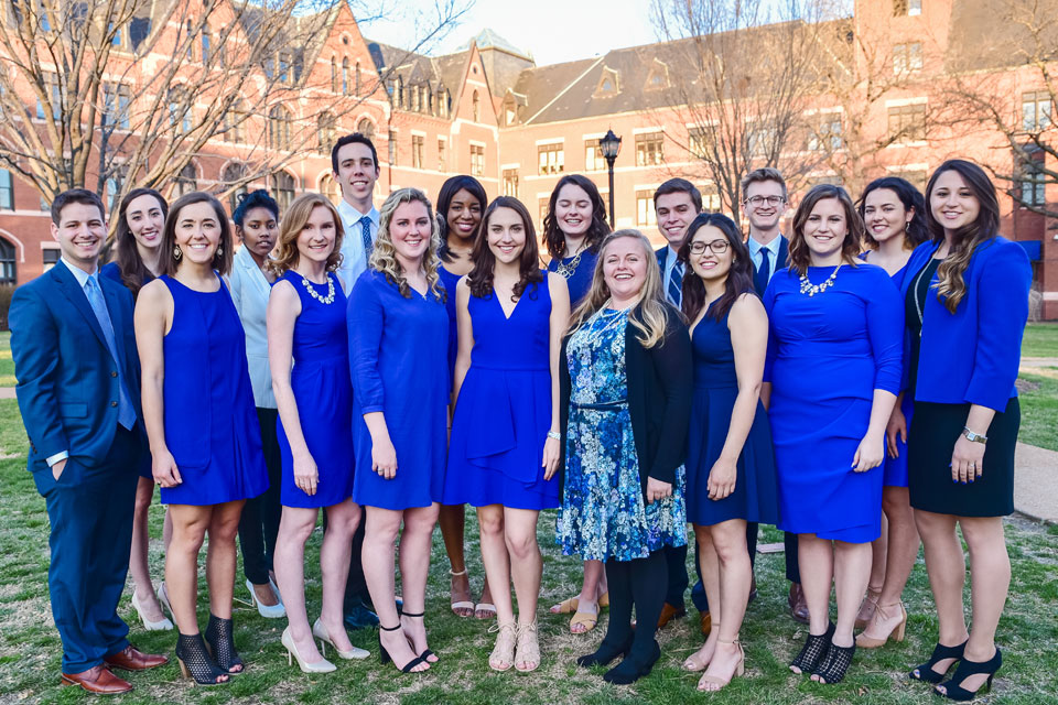 A group of students pose for a photo outside on campus.