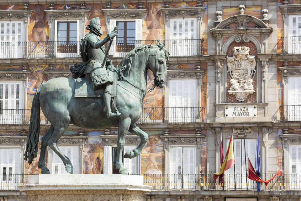 A statue of Philip the third riding a horse in the Plaza Mayor in Madrid, Spain.