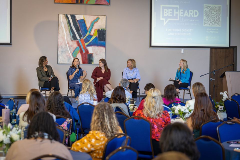 A woman speaks to a crowd during the Women in Leadership Panel at the Be Heard Women in Leadership Conference.