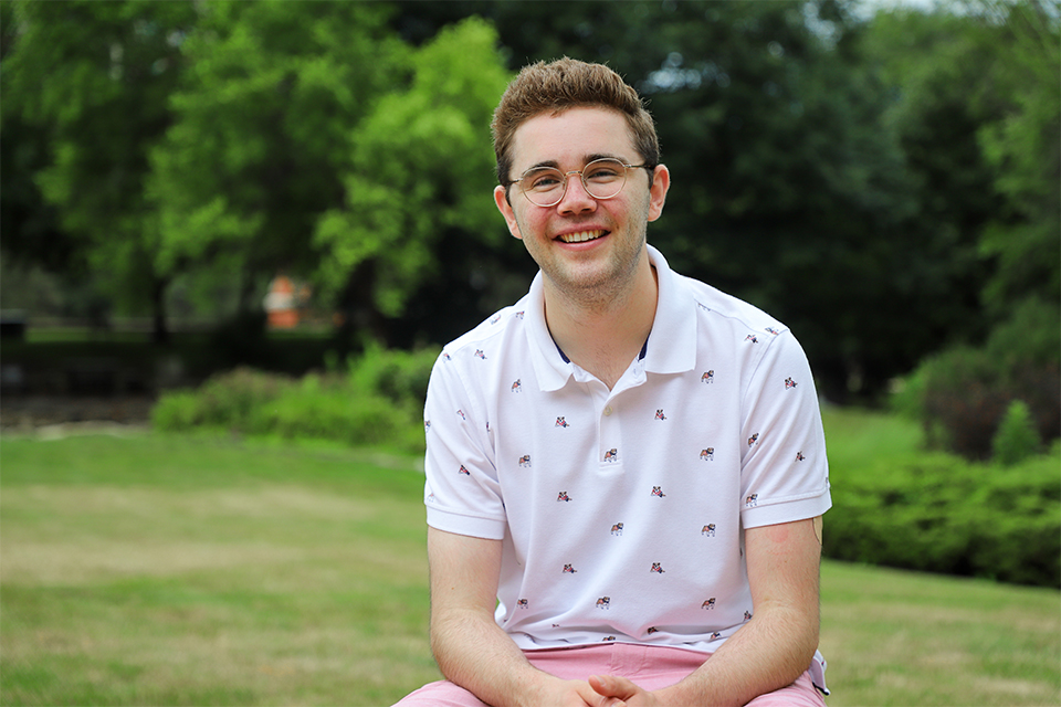 Henry Matus, 2021 Chaifetz School graduate poses for a photo on a sunny day outside the Chaifetz School of Business 