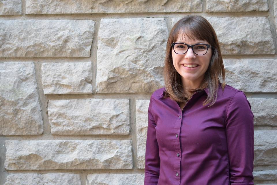 Dr. Katie Kelting, associate professor of marketing, poses for a photo in the atrium of Cook Hall at Siant Louis University's Chaifetz School of Business.