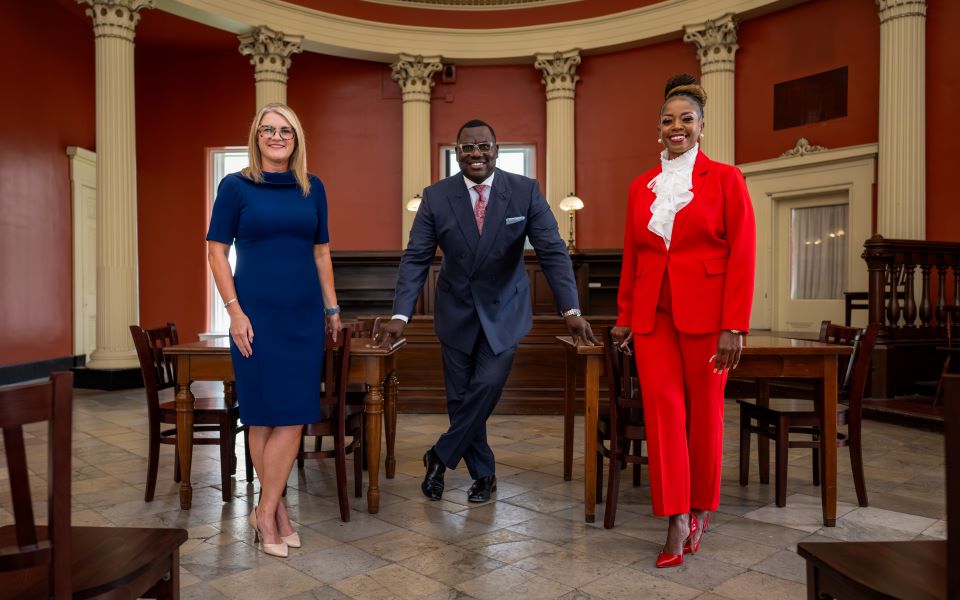 Jen Crompton, Untress Quinn, and Monique Abby pose in the old courthouse