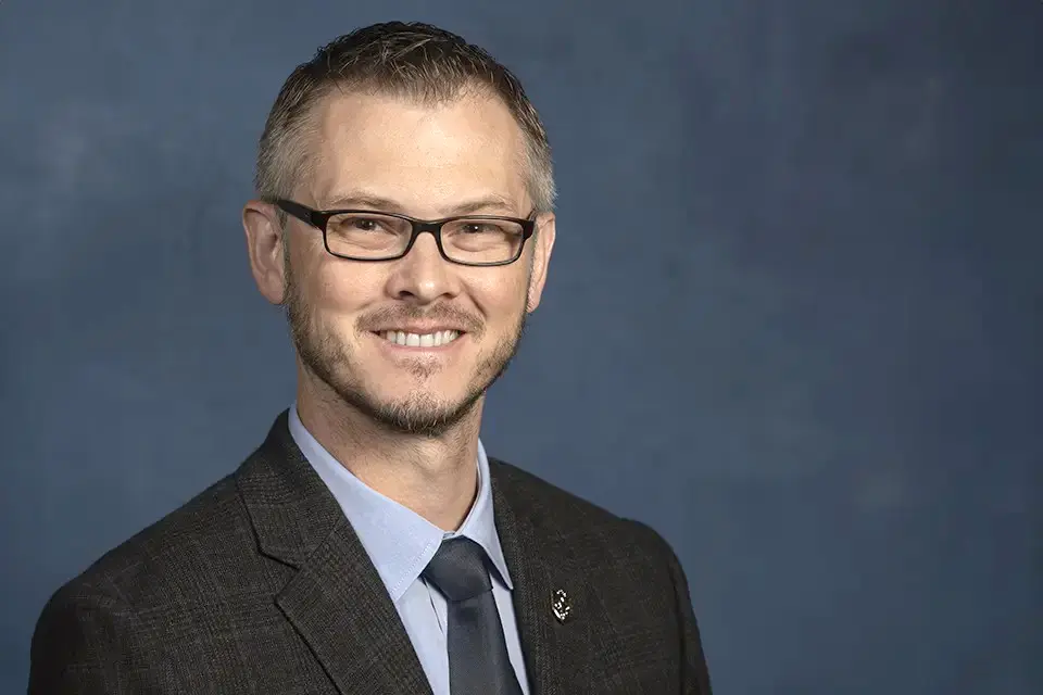 Headshot of William Johnson in a suit and tie.