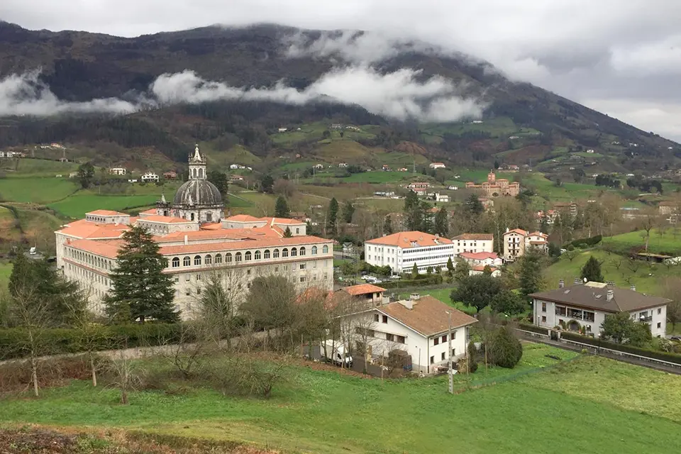 Aerial shot of sanctuary and basilica with lush greenery in the background.