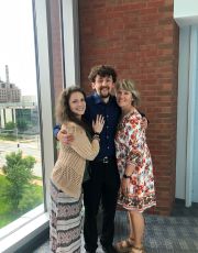 Reagan McGuffee stands with two others after successfully defending his dissertation.