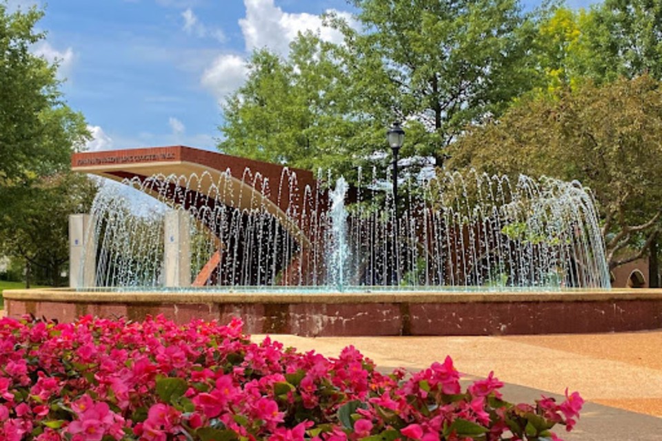 Exterior shot of a School of Medicine building with a fountain in front.