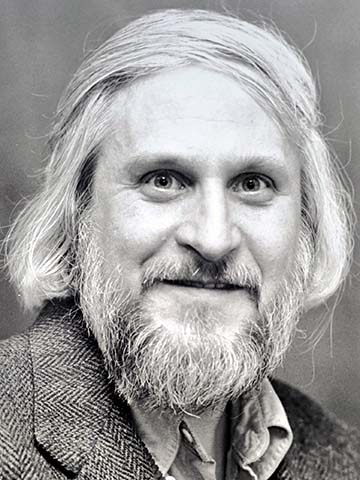 a headshot of a man in black and white