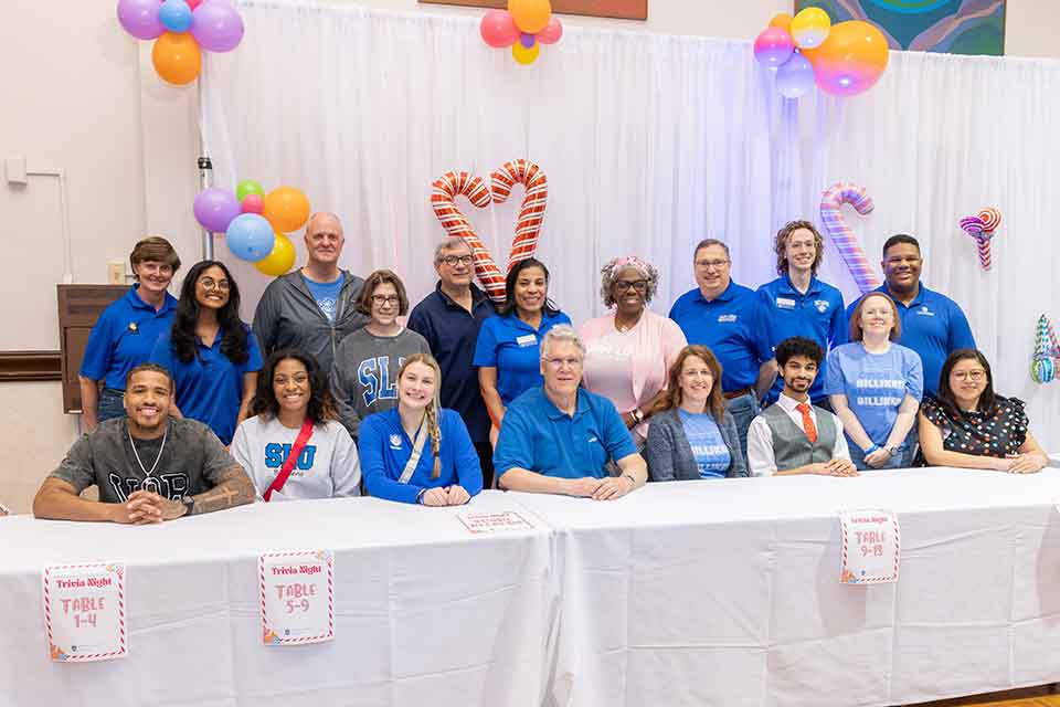 Attendees pose for a photo at a Billiken Family Network trivia night.