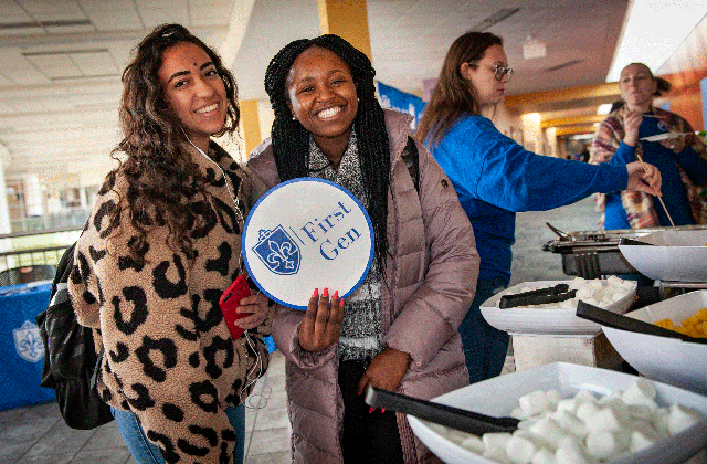 Two students facing the camera at a 1st Gen student event