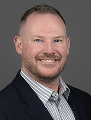 Smiling man in a white shirt and suit jacket